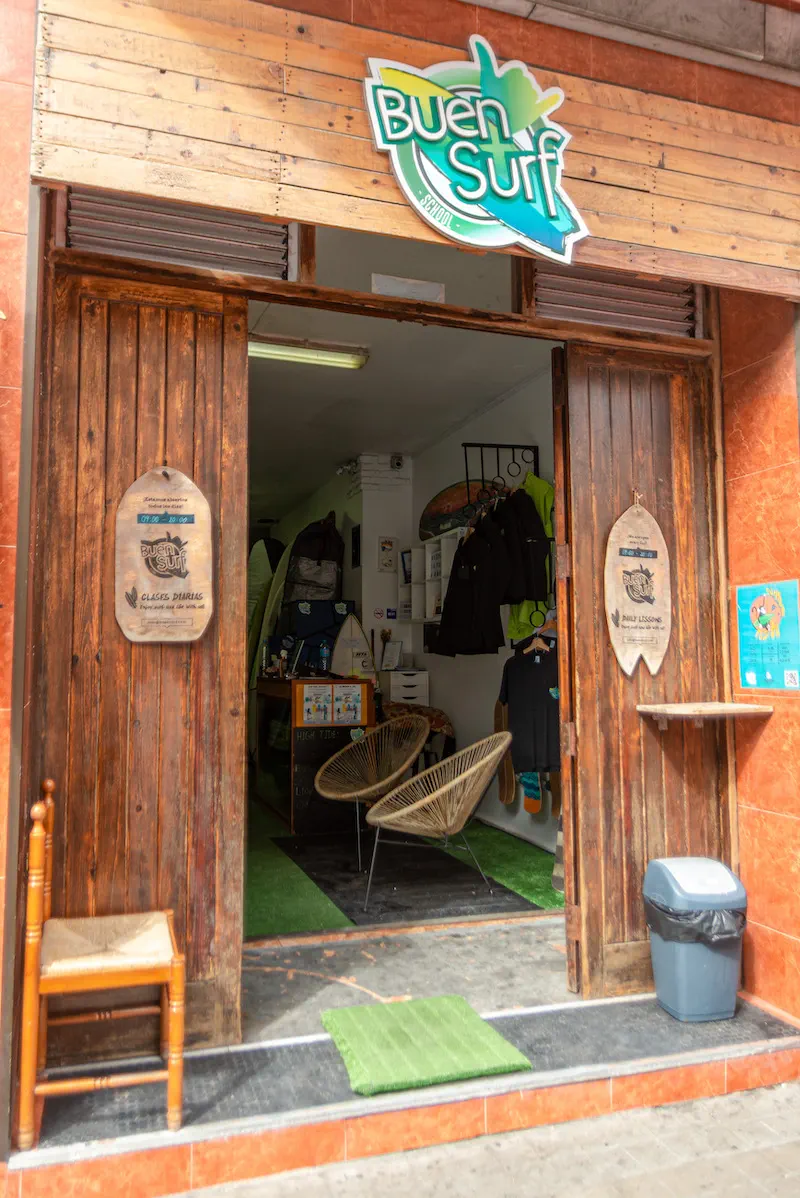 The open front of Buen Surf School on Calle Covadonga, with the sign above the doorway