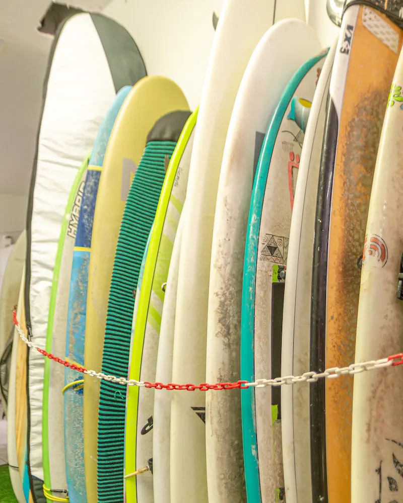 Boards standing in the rack inside the school, chained along the row